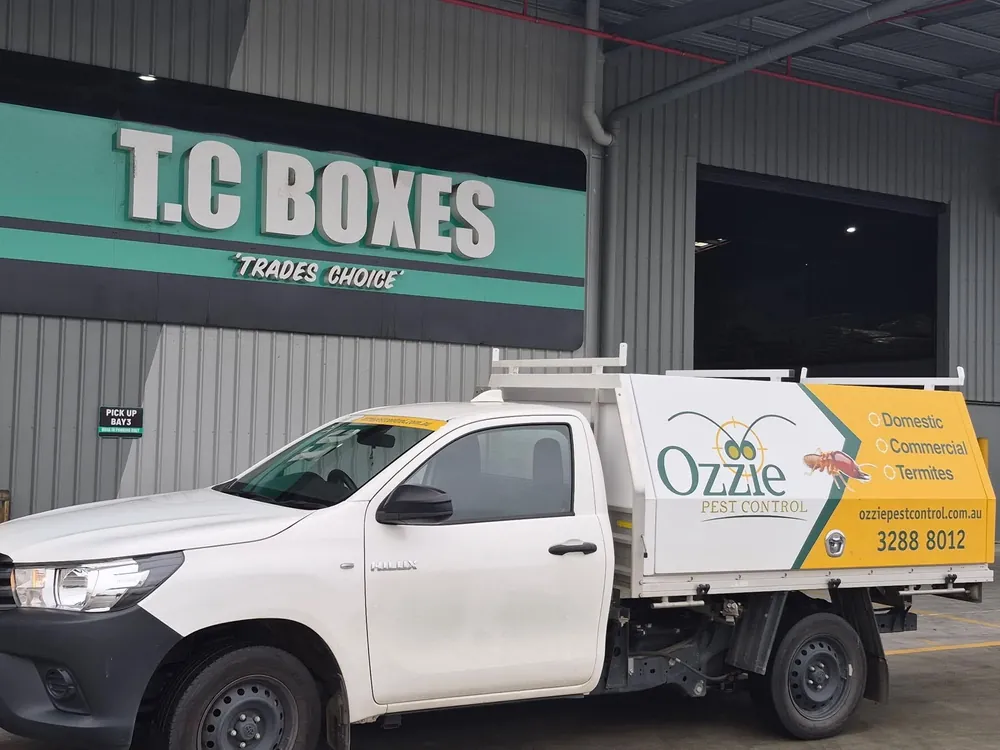 An Ozzie Pest Control Hilux parked at the roller door of a commercial warehouse